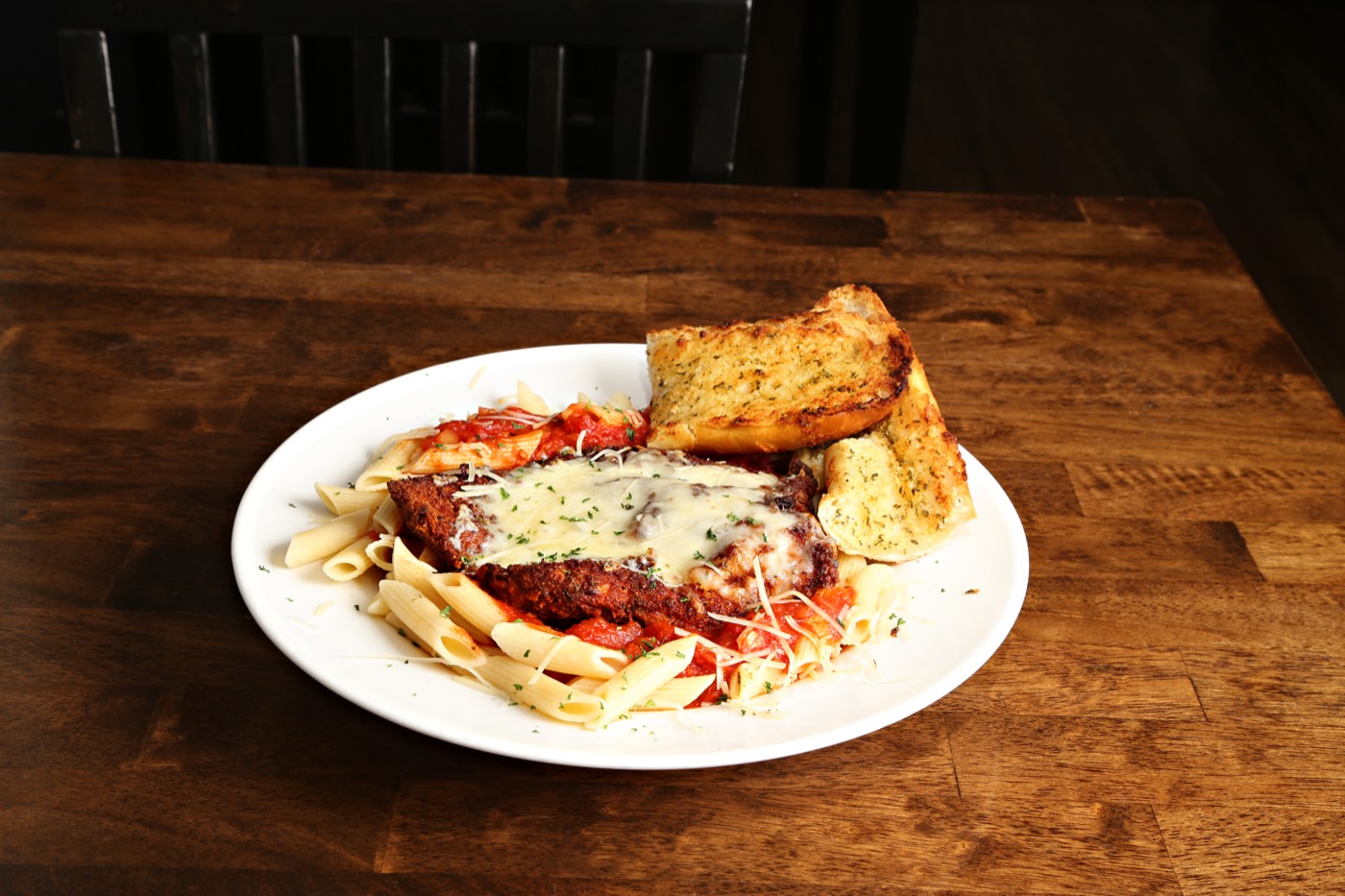 Chicken parmesan over penne with garlic bread
