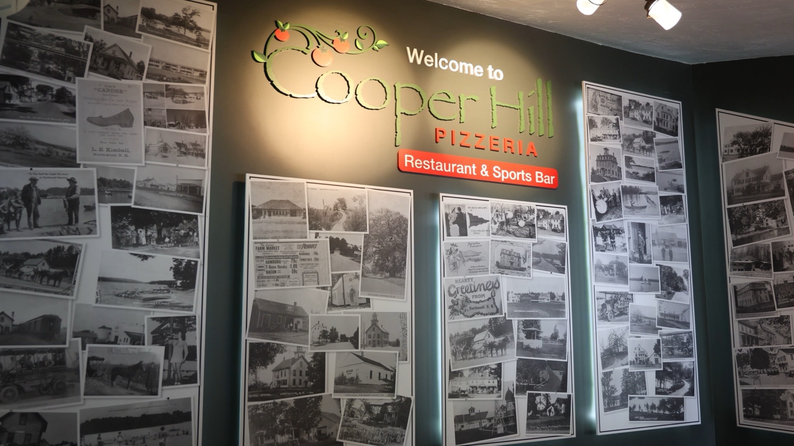 The Welcome to Cooper Hill wall, covered in historic photos of Northwood